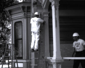 A picture of a contractor working on a Cappon House restoration project which will be discussed in the Holland Museum exhibit, "Authentically Victorian: Reflecting o the Cappon House Restoration" on display from March 1-July 29, 2024.