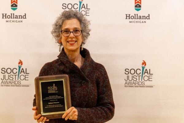 Ricki Levine with the Social Justice Award for Education.