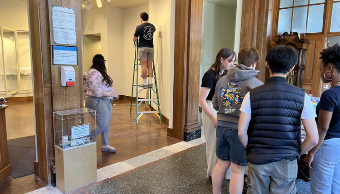 2024 Summer Interns preparing the exhibition, "Following in LEDA's Footsteps."